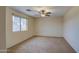 Simple bedroom with ceiling fan and large window at 9909 W Miami St, Tolleson, AZ 85353