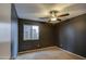 Dark-painted bedroom with ceiling fan and carpeting at 9909 W Miami St, Tolleson, AZ 85353