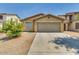 House exterior showing front yard, driveway, and two-car garage at 9909 W Miami St, Tolleson, AZ 85353