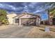 Single-story house with a two-car garage and desert landscaping at 9909 W Miami St, Tolleson, AZ 85353