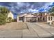 Single-story home with a two-car garage and landscaped front yard at 9909 W Miami St, Tolleson, AZ 85353