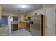 Kitchen with granite countertops and stainless steel refrigerator at 9909 W Miami St, Tolleson, AZ 85353