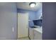 Bright laundry room, featuring washer, dryer, and extra storage at 9909 W Miami St, Tolleson, AZ 85353