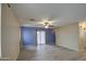 Living room with tile flooring and sliding glass door at 9909 W Miami St, Tolleson, AZ 85353