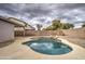 Irregular shaped pool with rock waterfall feature at 9909 W Miami St, Tolleson, AZ 85353