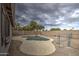 Irregular shaped pool with rock waterfall feature at 9909 W Miami St, Tolleson, AZ 85353