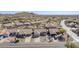 Aerial view of house and neighborhood, showcasing desert landscape and mountain views at 10255 E Golden Rim Cir, Gold Canyon, AZ 85118