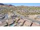 Aerial view of house and neighborhood, showcasing desert landscape and mountain views at 10255 E Golden Rim Cir, Gold Canyon, AZ 85118