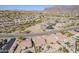 Aerial view of a residential neighborhood with desert landscape and mountains in the background at 10255 E Golden Rim Cir, Gold Canyon, AZ 85118