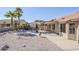 Large backyard with gravel, desert plants, and a covered patio with seating at 10255 E Golden Rim Cir, Gold Canyon, AZ 85118