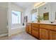 Bathroom with double vanity, large mirror, and a bathtub at 10255 E Golden Rim Cir, Gold Canyon, AZ 85118