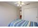 Bedroom with ceiling fan and sliding door to bath at 10255 E Golden Rim Cir, Gold Canyon, AZ 85118