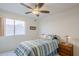 Bedroom with wood floors, ceiling fan and window at 10255 E Golden Rim Cir, Gold Canyon, AZ 85118