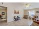 Living room with tiled floors, comfortable seating, and a ceiling fan at 10255 E Golden Rim Cir, Gold Canyon, AZ 85118
