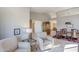 Spacious living room with two armchairs and a view into the dining area at 10255 E Golden Rim Cir, Gold Canyon, AZ 85118
