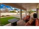 Covered patio with seating area, artificial turf, and built-in grill at 10428 E Hercules Dr, Sun Lakes, AZ 85248