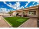 Artificial turf backyard with covered patio and putting green at 10428 E Hercules Dr, Sun Lakes, AZ 85248