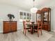 Bright dining room featuring a wood table, chairs, and elegant cabinetry at 10428 E Hercules Dr, Sun Lakes, AZ 85248