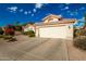 Two-car garage with driveway and desert landscaping at 10428 E Hercules Dr, Sun Lakes, AZ 85248