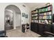 Home office features built-in bookshelves and an arched doorway at 10428 E Hercules Dr, Sun Lakes, AZ 85248