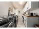 Laundry room with washer, dryer, and built-in workspace at 10428 E Hercules Dr, Sun Lakes, AZ 85248