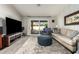 Spacious living room with large TV, comfortable seating, and sliding glass doors at 10428 E Hercules Dr, Sun Lakes, AZ 85248