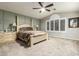 Spacious main bedroom with a king-size bed and a ceiling fan at 10428 E Hercules Dr, Sun Lakes, AZ 85248