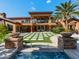 Expansive backyard with a pool, spa, manicured lawn, and outdoor seating areas, perfect for entertaining at 11571 E Cochise Dr, Scottsdale, AZ 85259