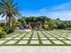 A backyard is designed with pavers, turf, and a covered patio at 11571 E Cochise Dr, Scottsdale, AZ 85259