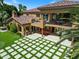 The outdoor space showcases a meticulously designed backyard with a patio, balcony, and green lawn at 11571 E Cochise Dr, Scottsdale, AZ 85259