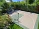 A private basketball court with lush green surroundings offers a great space for recreation and exercise at 11571 E Cochise Dr, Scottsdale, AZ 85259