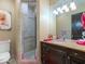 Elegant bathroom featuring a walk-in shower, dark wood vanity, and a marble countertop at 11571 E Cochise Dr, Scottsdale, AZ 85259