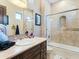 Well-lit bathroom features a tiled shower, stylish fixtures, and a large vanity at 11571 E Cochise Dr, Scottsdale, AZ 85259