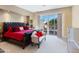 Elegant Primary bedroom with patio access and red bedding at 11571 E Cochise Dr, Scottsdale, AZ 85259