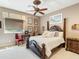 Cozy bedroom featuring a four-poster bed, ceiling fan, and natural light at 11571 E Cochise Dr, Scottsdale, AZ 85259