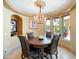 Cozy breakfast nook with a round table and views to backyard at 11571 E Cochise Dr, Scottsdale, AZ 85259