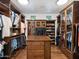 Large walk-in closet with ample shelving and hanging space at 11571 E Cochise Dr, Scottsdale, AZ 85259