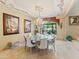 Formal dining room with a large table, chandelier, and scenic artwork at 11571 E Cochise Dr, Scottsdale, AZ 85259