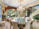 Elegant dining room with a decorative table, chandelier, and staircase view at 11571 E Cochise Dr, Scottsdale, AZ 85259