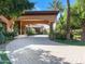 Curved driveway leading to the grand entrance of a beautiful home, surrounded by lush landscaping at 11571 E Cochise Dr, Scottsdale, AZ 85259