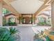 Elegant home entrance with a covered portico, decorative planters, and manicured landscaping at 11571 E Cochise Dr, Scottsdale, AZ 85259