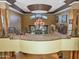 An grand entryway with a large chandelier and open staircase, creating a dramatic and welcoming atmosphere at 11571 E Cochise Dr, Scottsdale, AZ 85259
