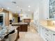 Spacious kitchen featuring granite countertops, custom cabinets, and a large island at 11571 E Cochise Dr, Scottsdale, AZ 85259