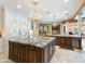 Bright kitchen with granite countertops, a center island, and custom cabinetry at 11571 E Cochise Dr, Scottsdale, AZ 85259