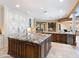 Spacious kitchen with a large island, granite countertops, and custom cabinetry at 11571 E Cochise Dr, Scottsdale, AZ 85259