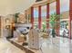 Bright and airy living room with tall windows and a cozy seating arrangement at 11571 E Cochise Dr, Scottsdale, AZ 85259