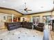 A large, inviting living room featuring an oversized leather sectional and views of the outdoor living space at 11571 E Cochise Dr, Scottsdale, AZ 85259