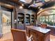 Home office with built-in bookshelves and a large desk at 11571 E Cochise Dr, Scottsdale, AZ 85259