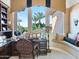 Home office area featuring a custom desk, window seat, and ample natural light at 11571 E Cochise Dr, Scottsdale, AZ 85259