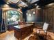 Home office with large windows, a desk, and rich wood finishes at 11571 E Cochise Dr, Scottsdale, AZ 85259